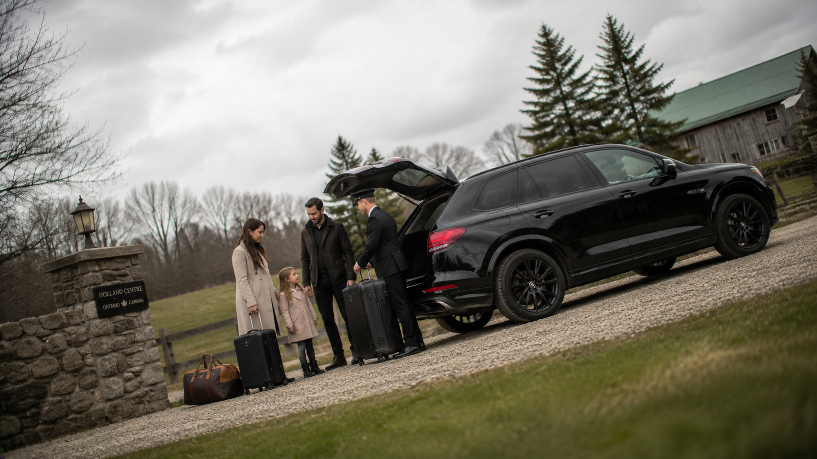 Professional chauffeur opening a luxury SUV for a traveller in Holland Centre, Ontario